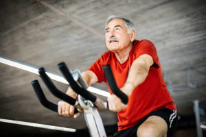 Pedaling for Parkinson's:Picture of Senior man on exercise bike.