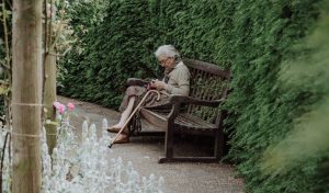woman sitting on brown bench