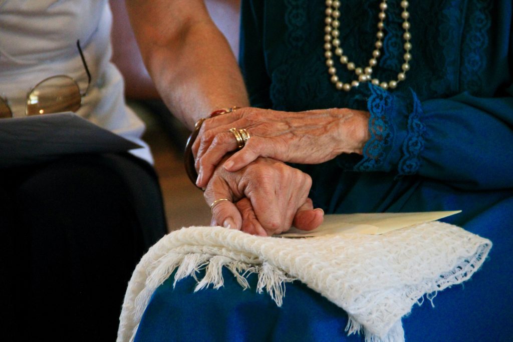 Walton Law - Elderly couple holding hands.