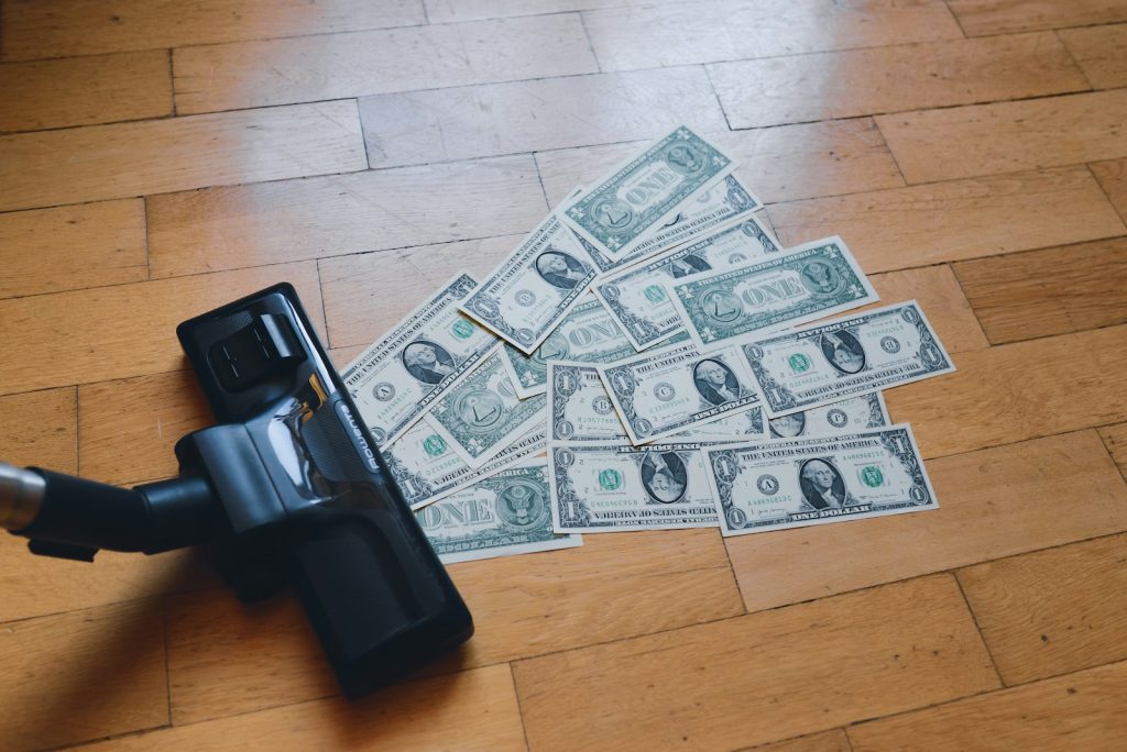 Inflation-fighting strategies, a pile of money sitting on top of a wooden floor